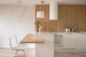 Modern and minimalist kitchen with white furniture, a beautiful and functional space like the ones made by the construction companies in New Orleans.