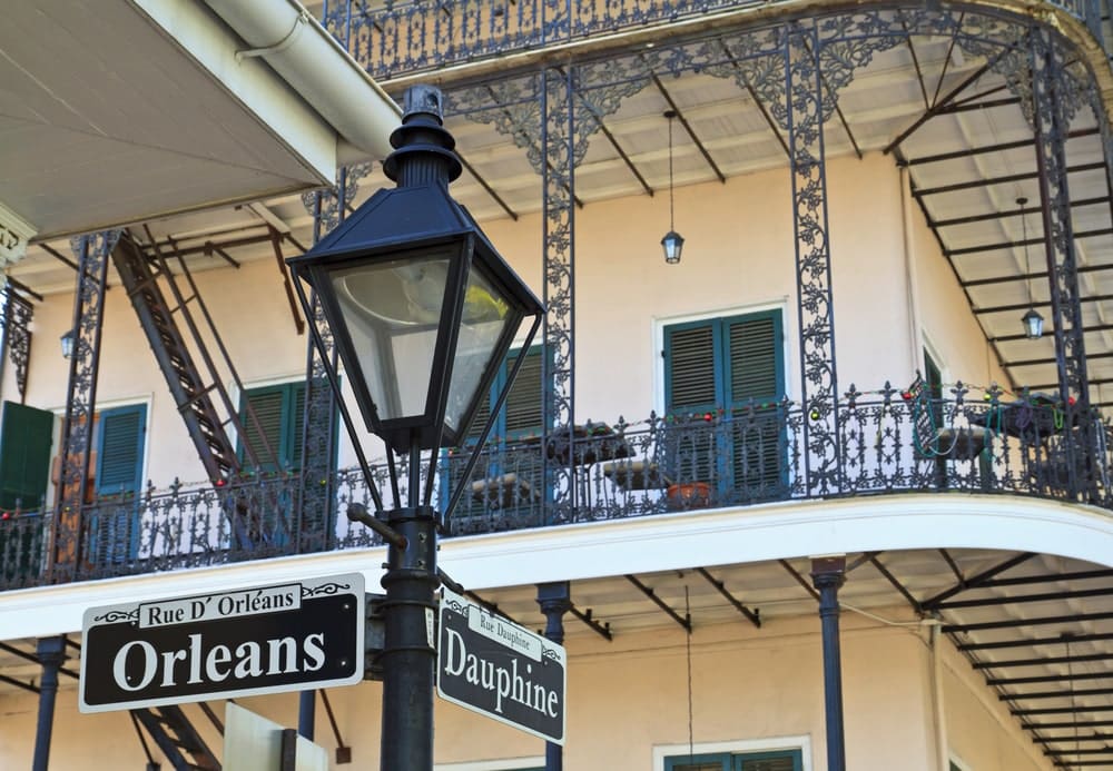 A lamp post and wrought iron balconies at the corner of Orleans and Dauphine streets in the French Quarter of New Orleans