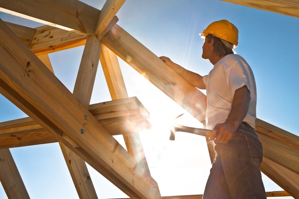 Skilled Worker from a construction company Actively Engaged in the Construction of a New Home