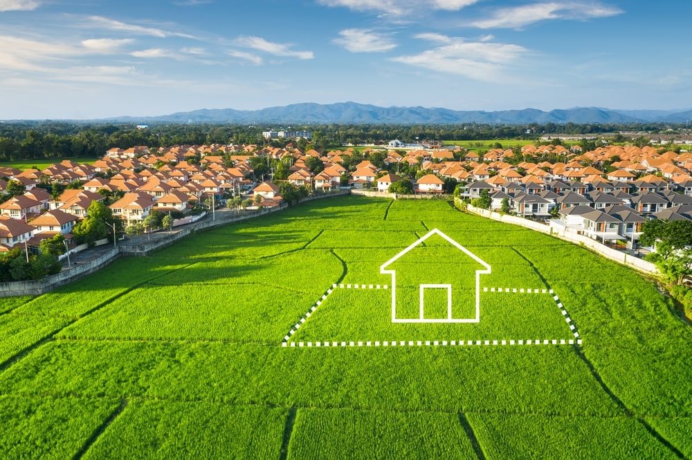 Land of green field in aerial view. Icon of residential, home or house building - construction companies new orleans